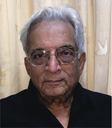 Portrait photo of Dr DD Tanna, elderly man with glasses and white hair