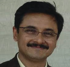 Portrait photo of Dr Harshad Argekar, middle-aged man with glasses and mustache