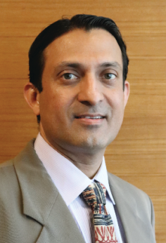 Portrait photo of Dr Atul Bhaskar, middle-aged man with glasses and mustache