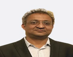 Portrait photo of Dr Taral Nagda, middle-aged man with glasses and mustache