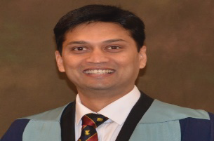 Portrait photo of Dr Vinay Kumar Singh, middle-aged man with glasses and mustache
