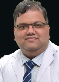 Portrait photo of Dr Shailesh Pai, middle-aged man with glasses and mustache