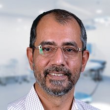 Portrait photo of Dr Mangal Parhar, middle-aged man with beard and glasses