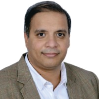 Portrait photo of Dr Aditya Menon, middle-aged man with glasses and mustache