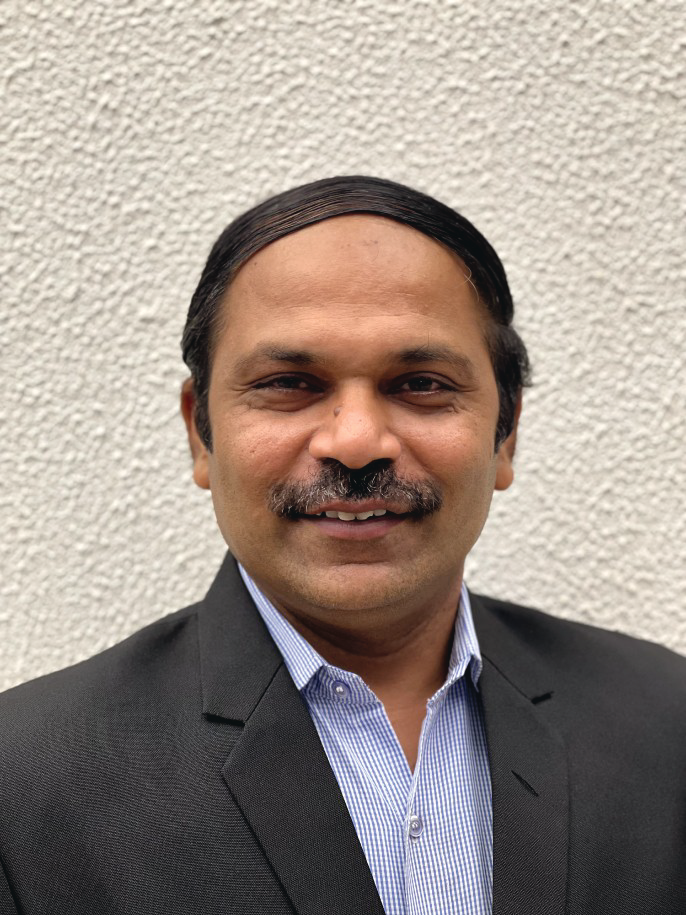 Portrait photo of Dr Hitesh Gopalan, middle-aged man with glasses and mustache
