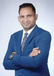 Portrait photo of Dr Ganesh Yeotiwad, middle-aged man with glasses and mustache