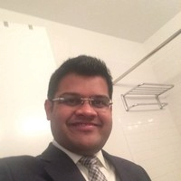 Portrait photo of Dr Binoy Shah, middle-aged man with glasses and mustache