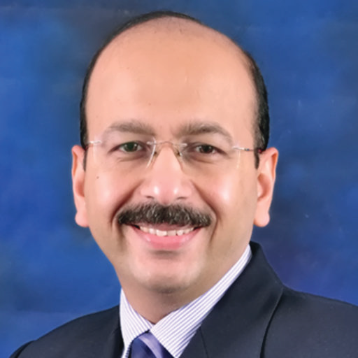 Portrait photo of Dr Vivek Trikha, middle-aged man with mustache and bald head
