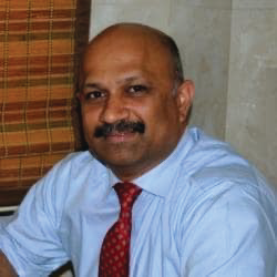 Portrait photo of Dr Nirbhay Karandikar, middle-aged man with glasses and mustache