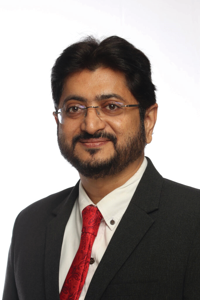 Portrait photo of Dr Atul Patil, middle-aged man with glasses and mustache