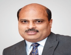 Portrait photo of Dr Satish Mutha, middle-aged man with glasses and mustache